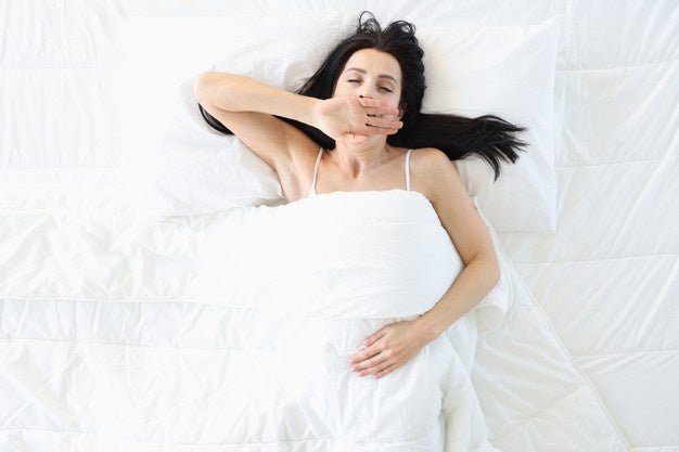Woman giving a New Mattress a chance by sleeping on it